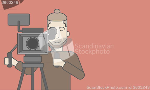 Image of Cameraman with beard looking through movie camera