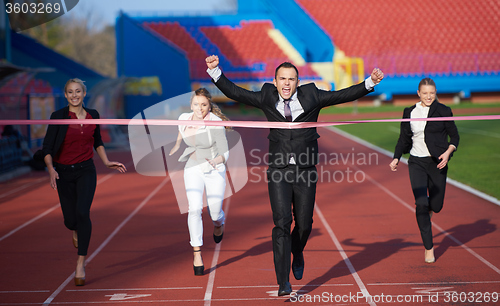 Image of business people running on racing track