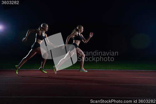 Image of athletic runners passing baton in relay race