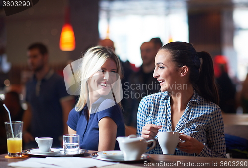 Image of girls have cup of coffee in restaurant