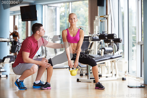 Image of young sporty woman with trainer exercise weights lifting