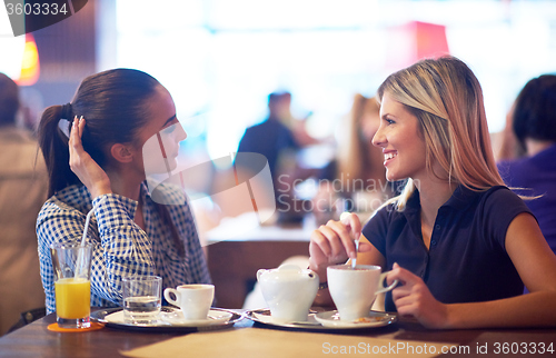 Image of girls have cup of coffee in restaurant