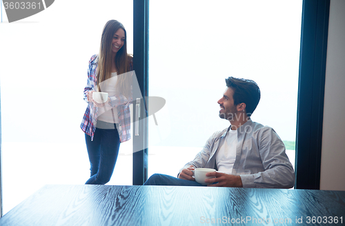 Image of relaxet young couple drink first morning coffee