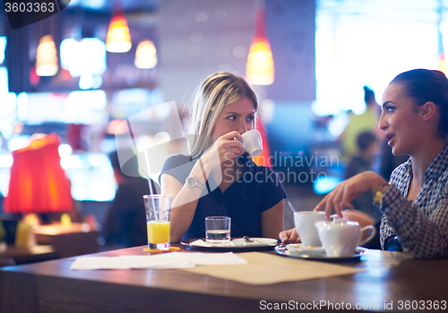 Image of girls have cup of coffee in restaurant