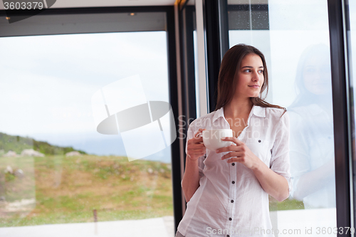 Image of beautiful young woman drink first morning coffee