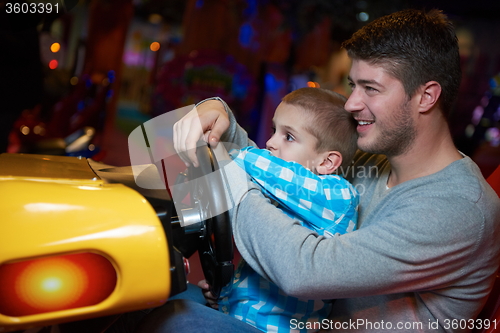 Image of father and son playing game in playground