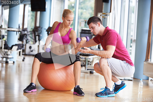 Image of young sporty woman with trainer exercise weights lifting