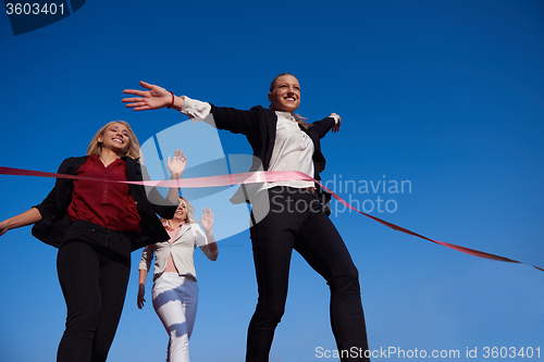 Image of business people running on racing track