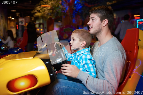 Image of father and son playing game in playground