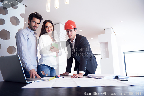 Image of couple buying new home with real estate agent