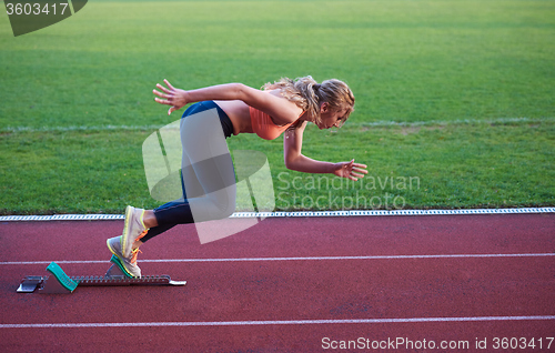 Image of pixelated design of woman  sprinter leaving starting blocks