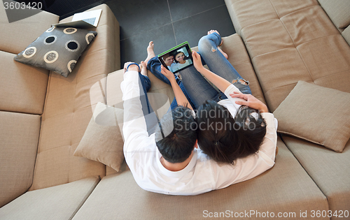 Image of couple at modern home using tablet computer