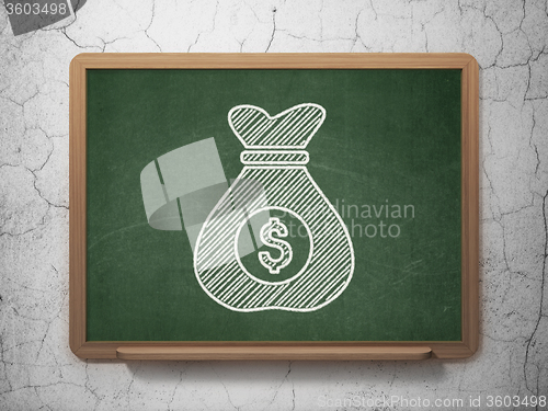 Image of Finance concept: Money Bag on chalkboard background