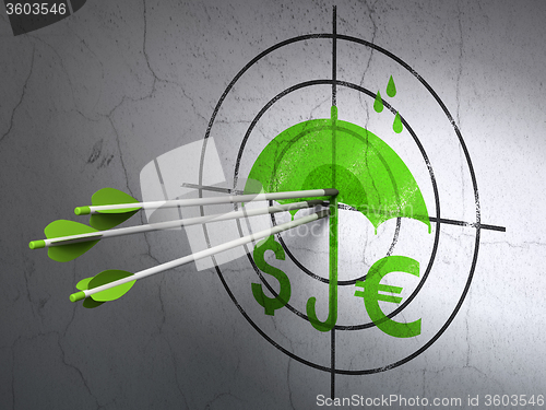 Image of Protection concept: arrows in Money And Umbrella target on wall background