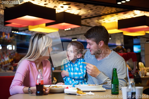 Image of family having lunch in shopping mall