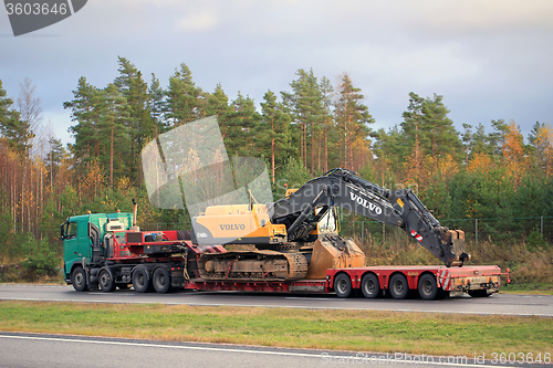 Image of Volvo FH truck hauls Volvo Hydraulic Crawler Excavator