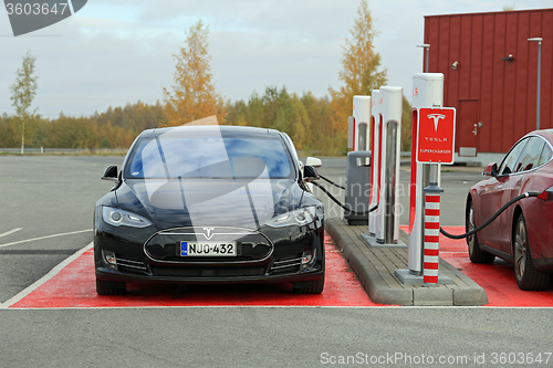 Image of Tesla Model S Cars Plugged In at Supercharger Station