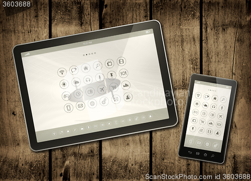Image of Smartphone and digital tablet PC with desktop icons on a dark wo