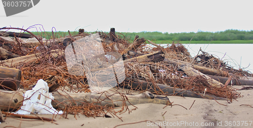 Image of Arctic lagoon is heavily infested with steel wire and logs