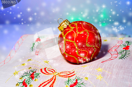 Image of Red Christmas ball on a napkin. Christmas decorations.