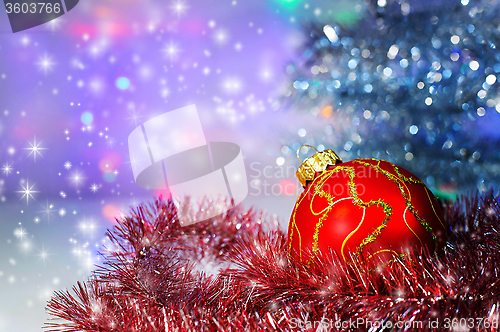 Image of Red Christmas ball under the tree and tinsel.Christmas decoratio