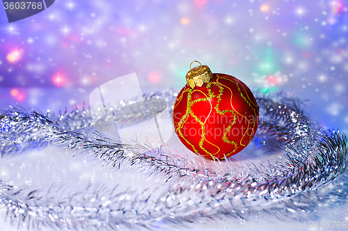 Image of Red Christmas-tree ball and tinsel. Christmas decorations.