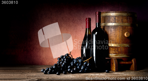 Image of Bottles with cask and grape