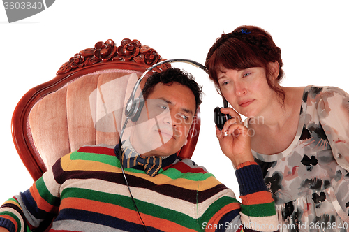 Image of Husband and wife listening on headphone.