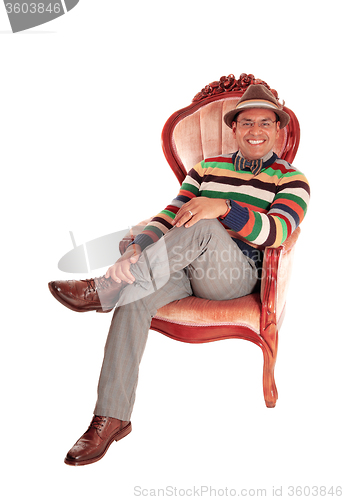Image of Smiling middle age man in armchair.