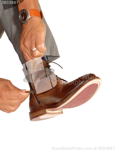 Image of Man putting on his shoes.