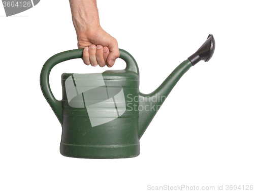 Image of Hand holding green watering can