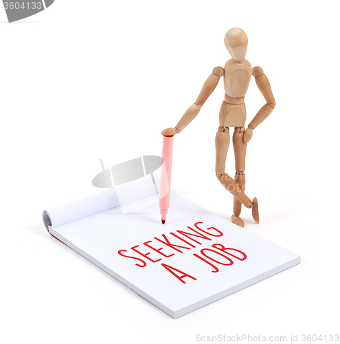 Image of Wooden mannequin writing - Seeking a job