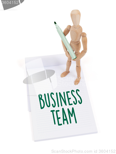 Image of Wooden mannequin writing - Business team