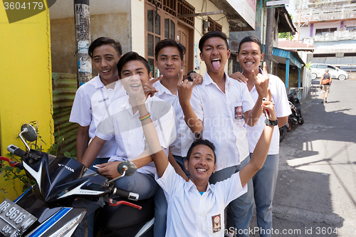 Image of young happy muslim students in white uniform