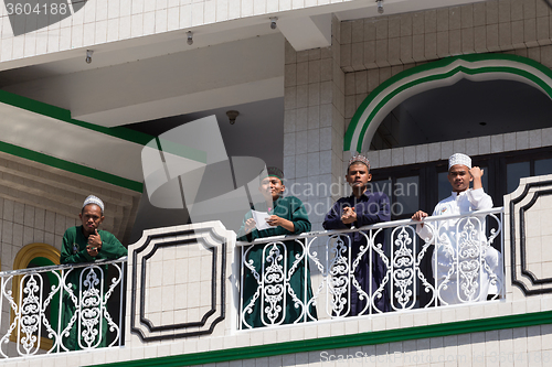 Image of young happy muslim teenagers in mosque