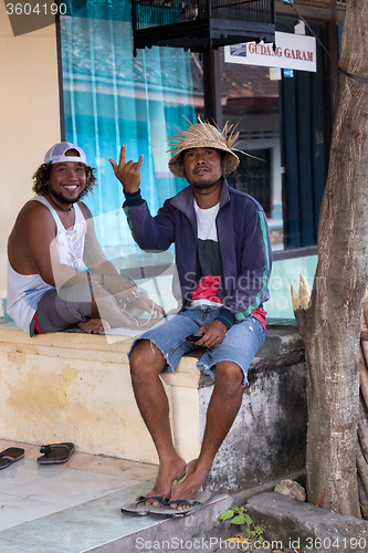 Image of men resting on street market, Bali