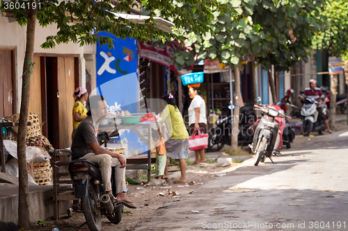 Image of man resting on street market, Bali