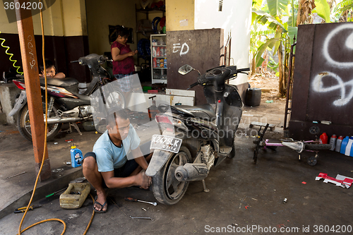 Image of Service man repair deflated damaged tyre