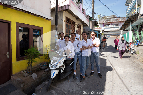 Image of young happy muslim students in white uniform