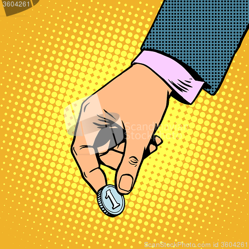 Image of Monetary contribution. The hand holds a coin. Business concept