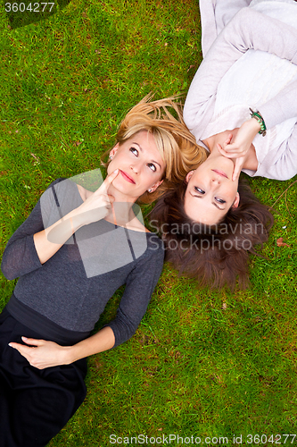 Image of Two girls lying in the grass