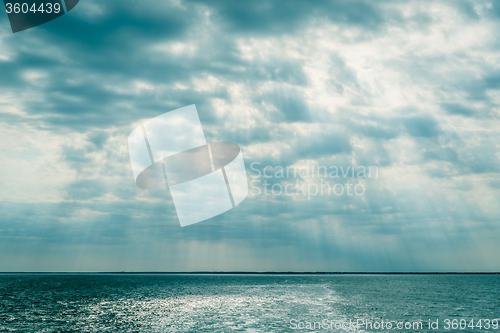 Image of Clouds over the ocean with sunbeams