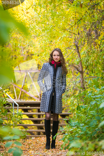 Image of Girl walks in the warm autumn weather