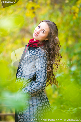 Image of Portrait of a happy girl walking in the autumn forest