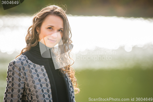 Image of Portrait of a young girl on a background autumn coat River