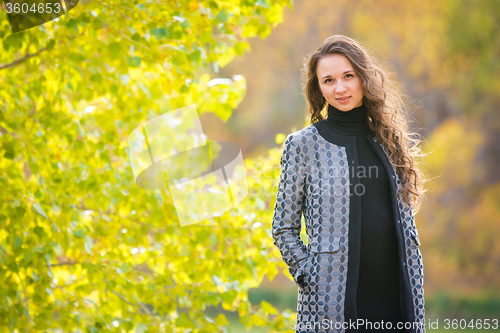 Image of Cute young girl on the background of the autumn yellow forests