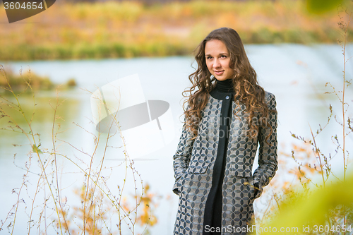 Image of Portrait of a young girl on a background of the autumn river