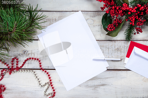 Image of The blank sheet of paper on the wooden table with a pen 