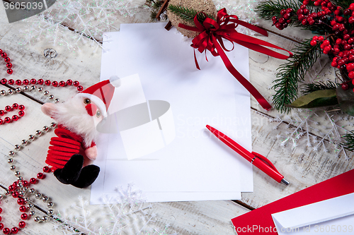 Image of The blank sheet of paper on the wooden table with a pen 