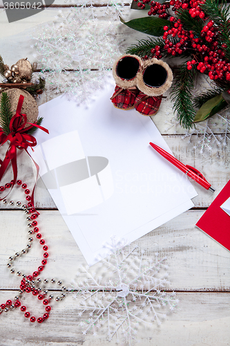 Image of The blank sheet of paper on the wooden table with a pen 